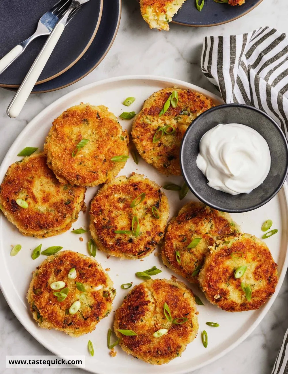 Crispy mashed potato pancakes served with sour cream and chives