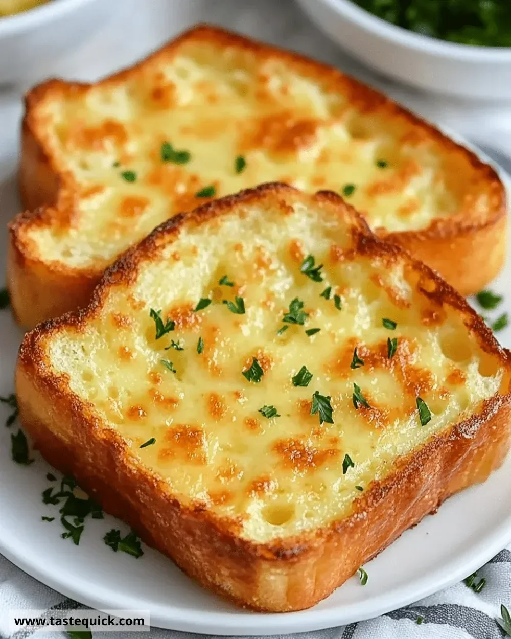 Cheesy Texas Toast topped with melted cheese and herbs on crispy bread