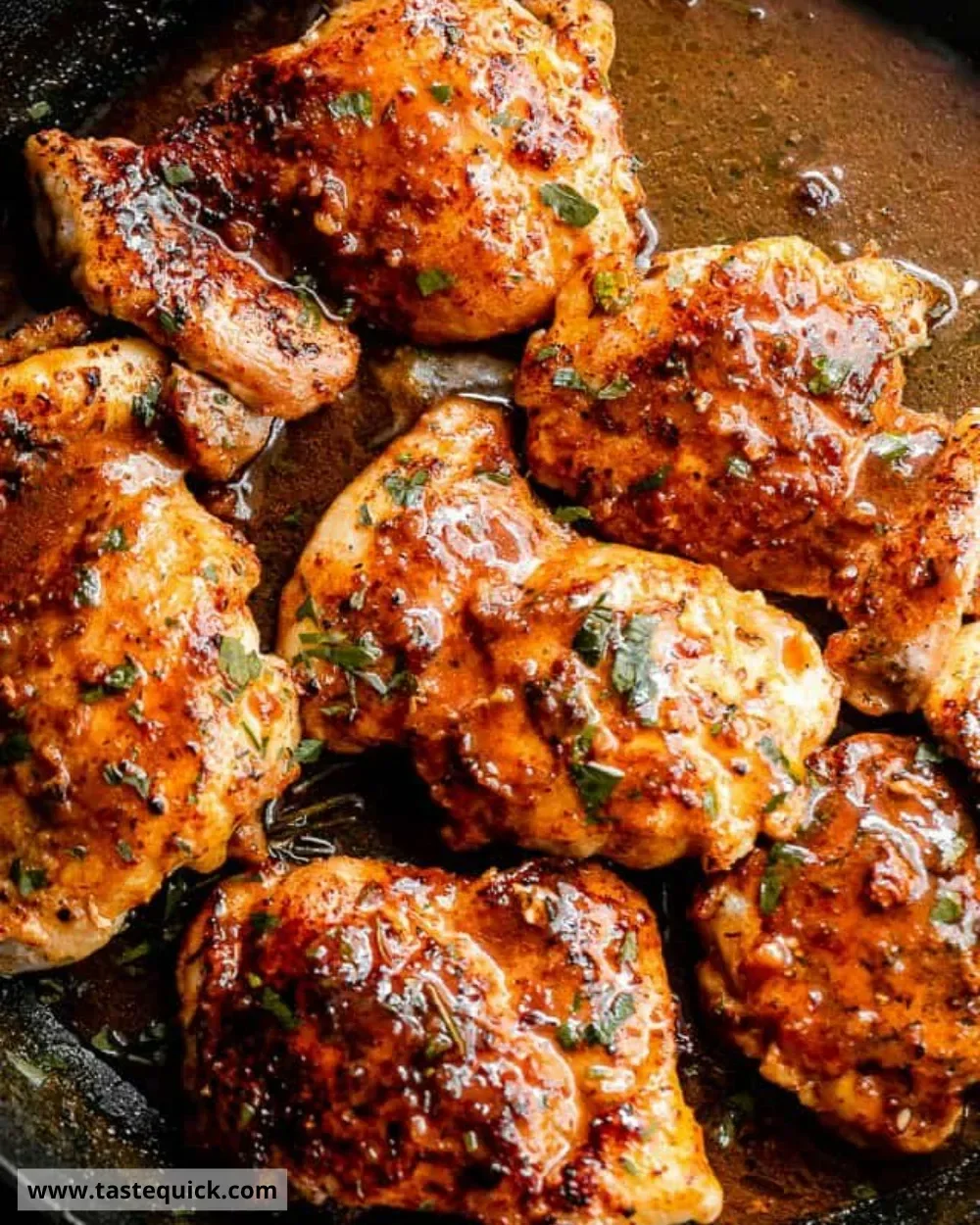 Crockpot Apple Cider Chicken Thighs served with herbs and apples.