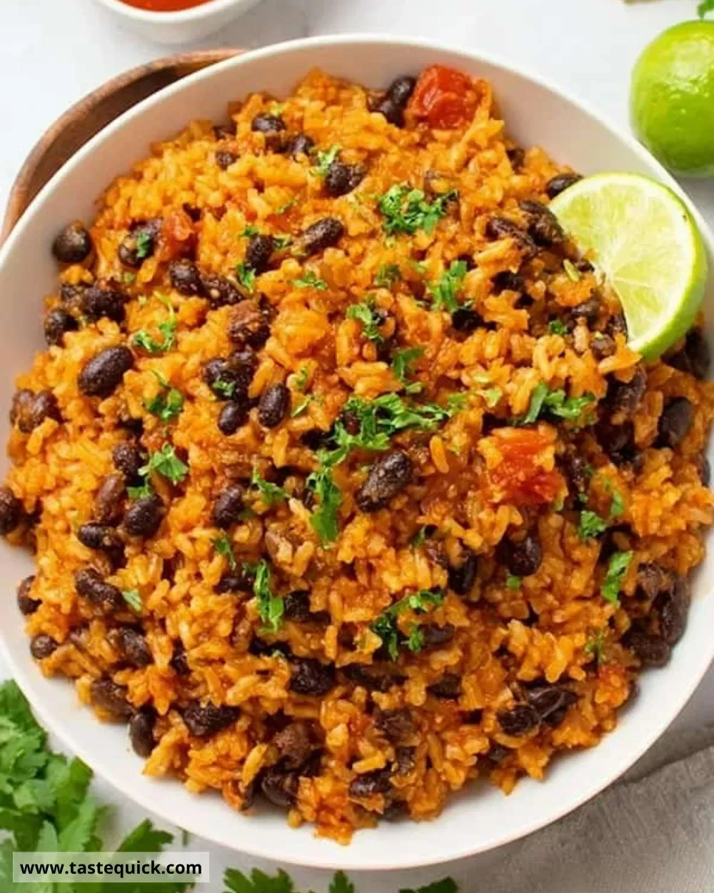 A bowl of easy rice and beans topped with herbs and spices.