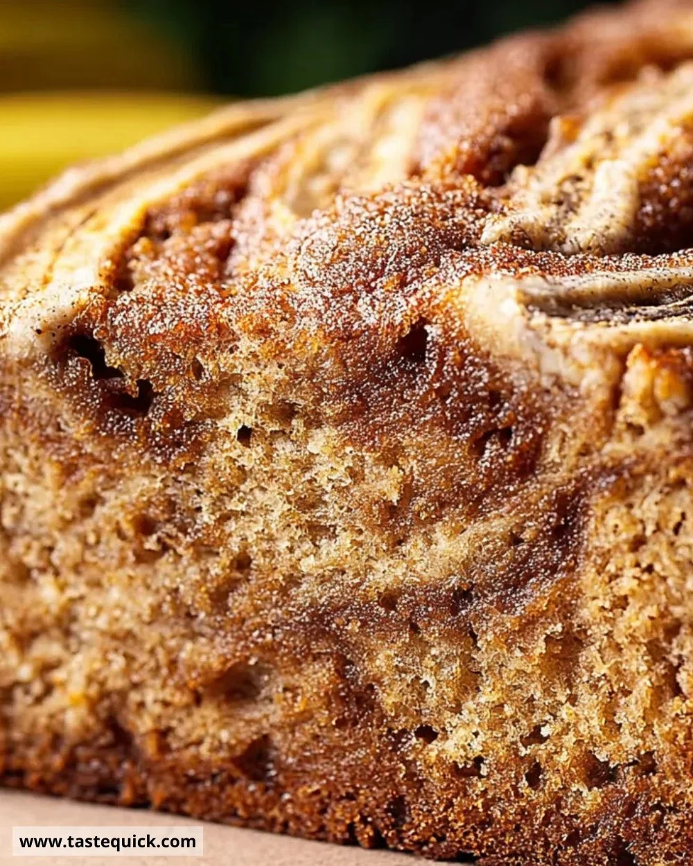 Loaf of flourless cinnamon swirl banana bread sliced on a wooden board