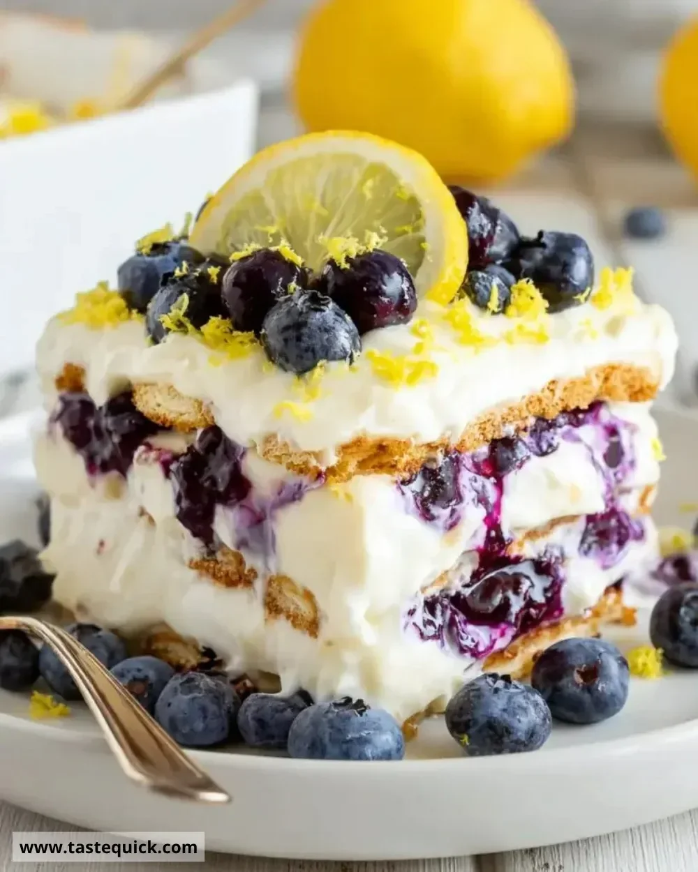 Lemon Blueberry Icebox Cake served on a plate with fresh blueberries and lemon slices