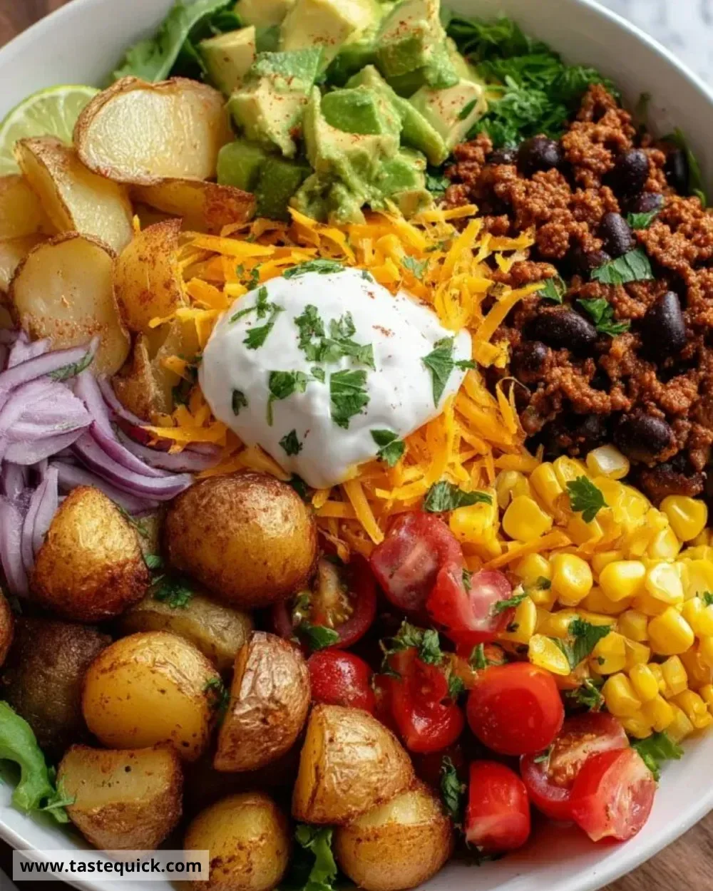 Loaded Potato Taco Bowl with toppings in a colorful dish