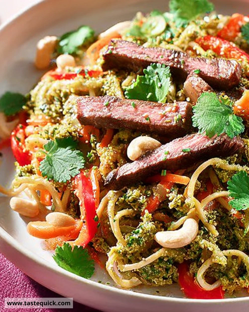 Plate of miso steak served with colorful noodle salad.