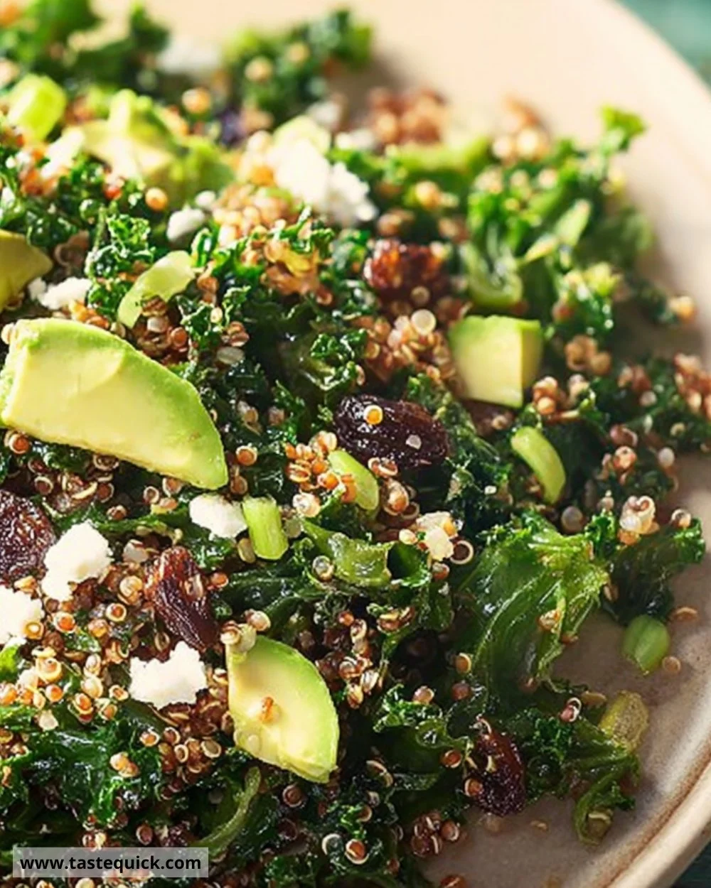 Quinoa salad with shredded greens and raisins served in a bowl