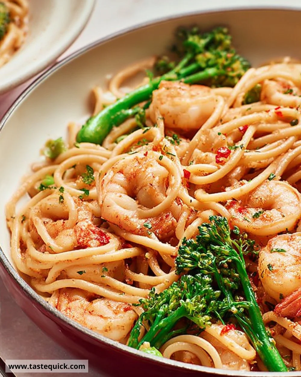 Sriracha and lime prawn linguine served with fresh herbs and lime wedges