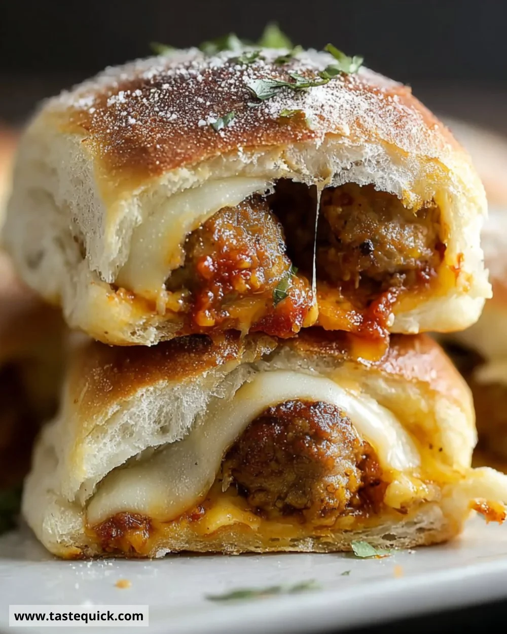 Stuffed ciabatta rolls with Italian sausage and melted cheese on a plate