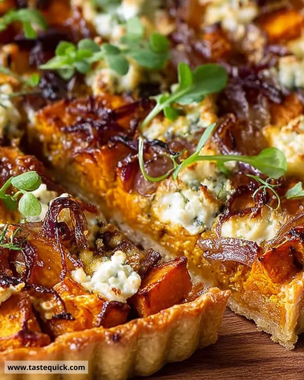 Sweet potato tart with feta and caramelised onions on a plate