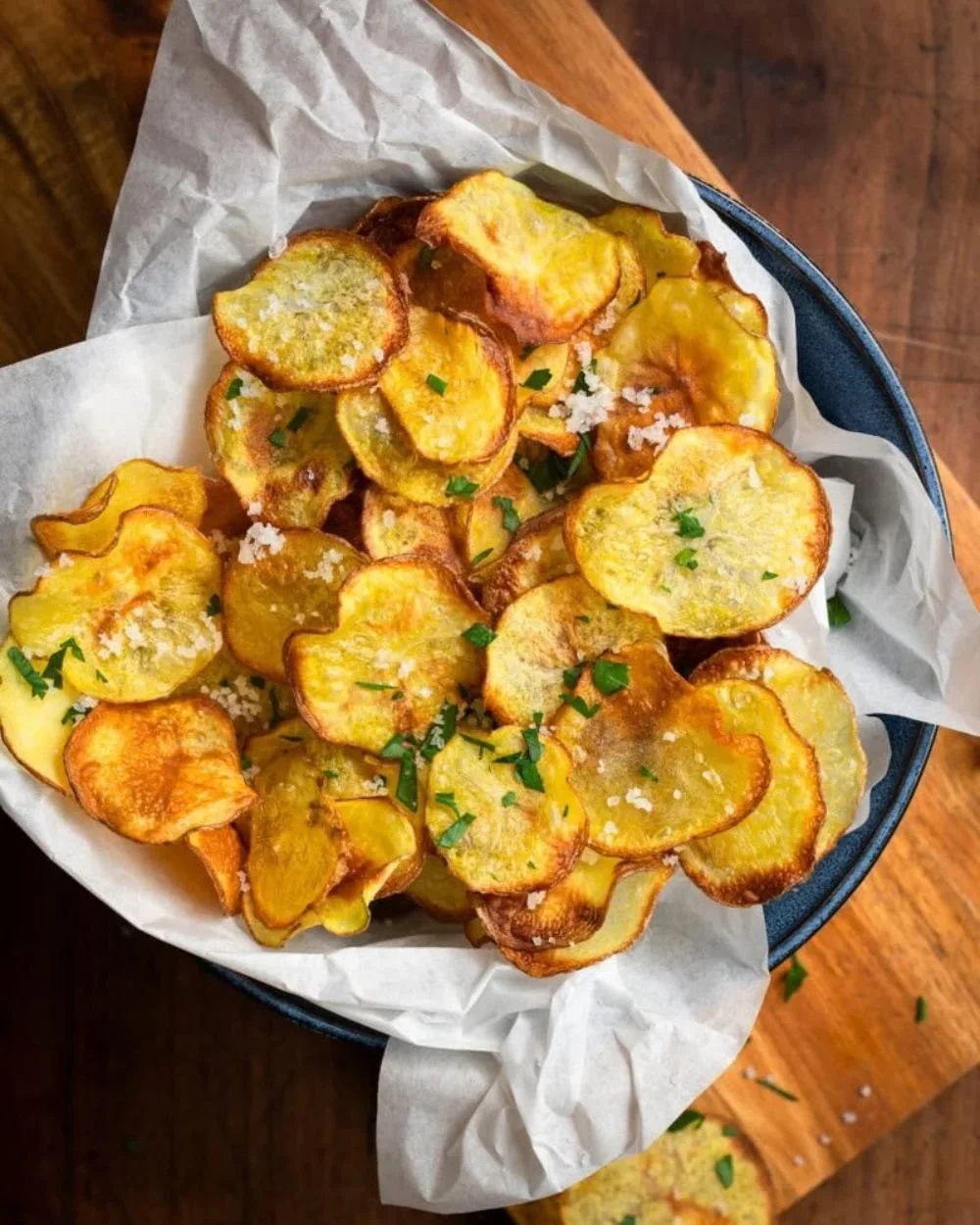 Bowl of crispy air-fried chips served with a dipping sauce