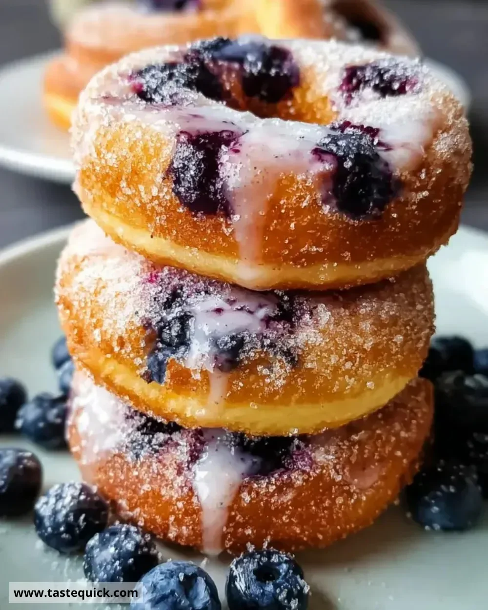 Air fryer blueberry donuts freshly made with plump blueberries and a light glaze.
