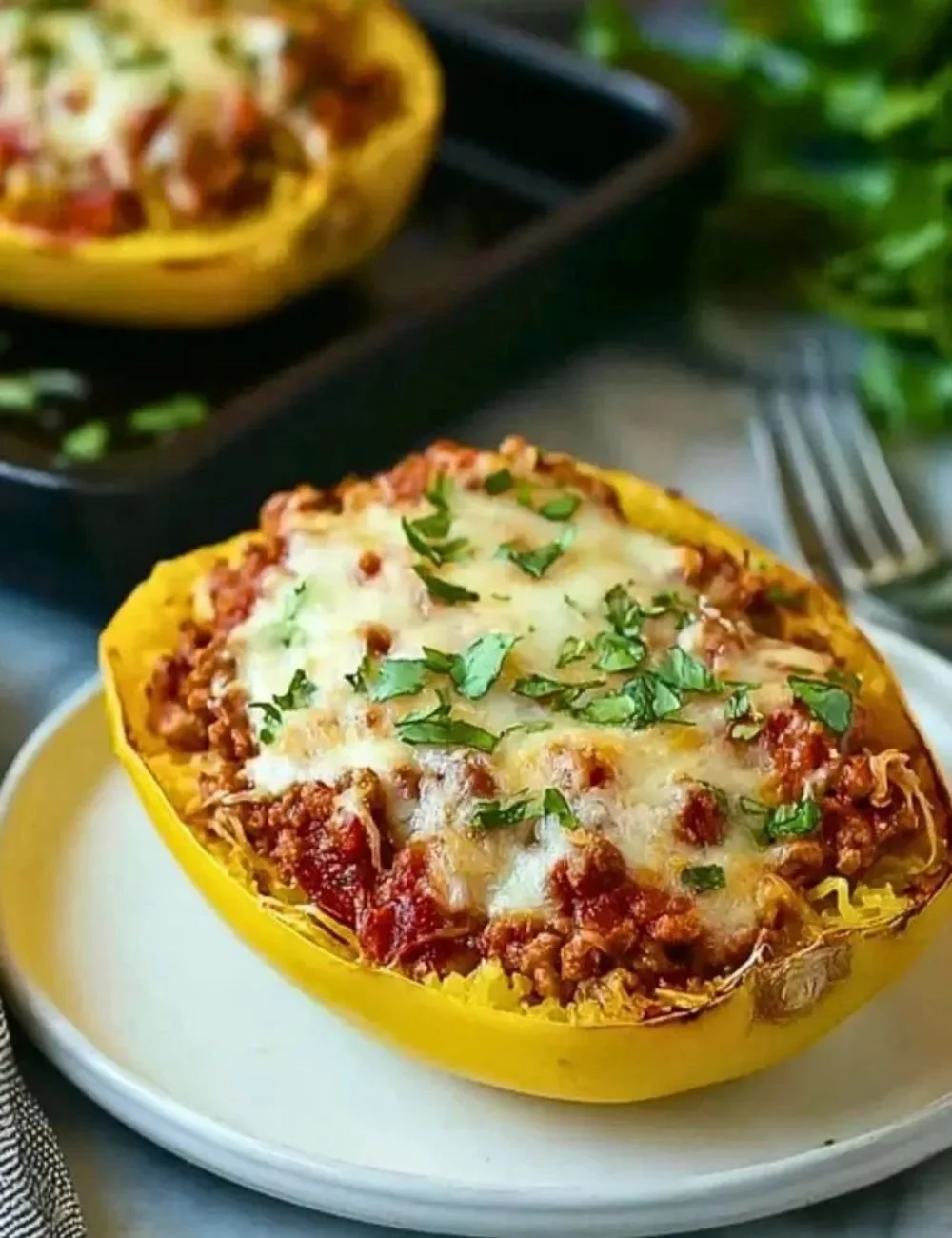 Cheesy garlic and herb spaghetti squash topped with rich meat sauce