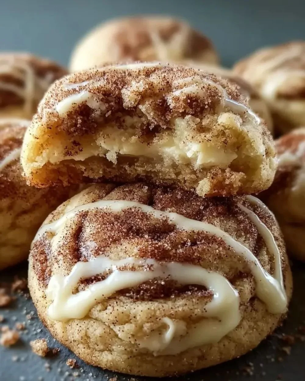Cinnamon roll cheesecake cookies on a rustic wooden table.