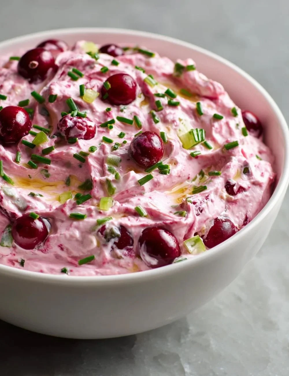 Cranberry Jalapeño Dip in a bowl with fresh ingredients around it