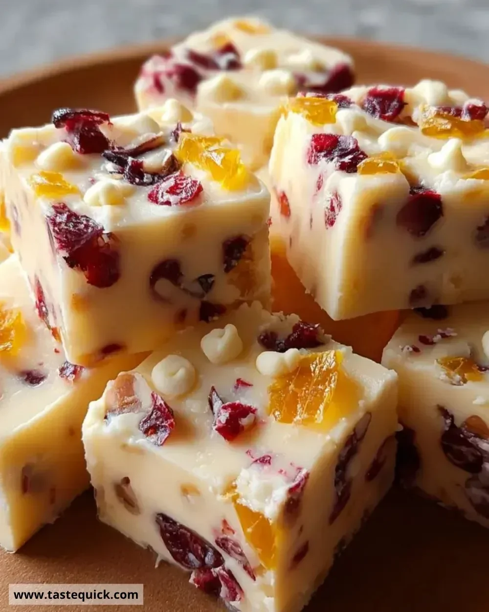 Cranberry Orange Fudge with vibrant red and orange colors on a rustic wooden background
