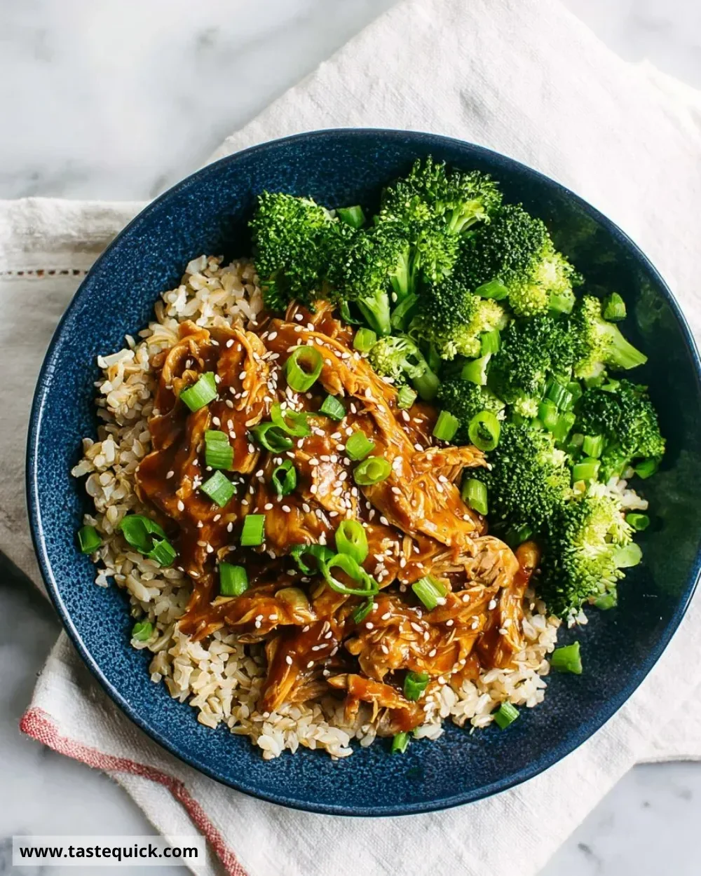 Slow cooker honey garlic chicken served on a plate with vegetables.