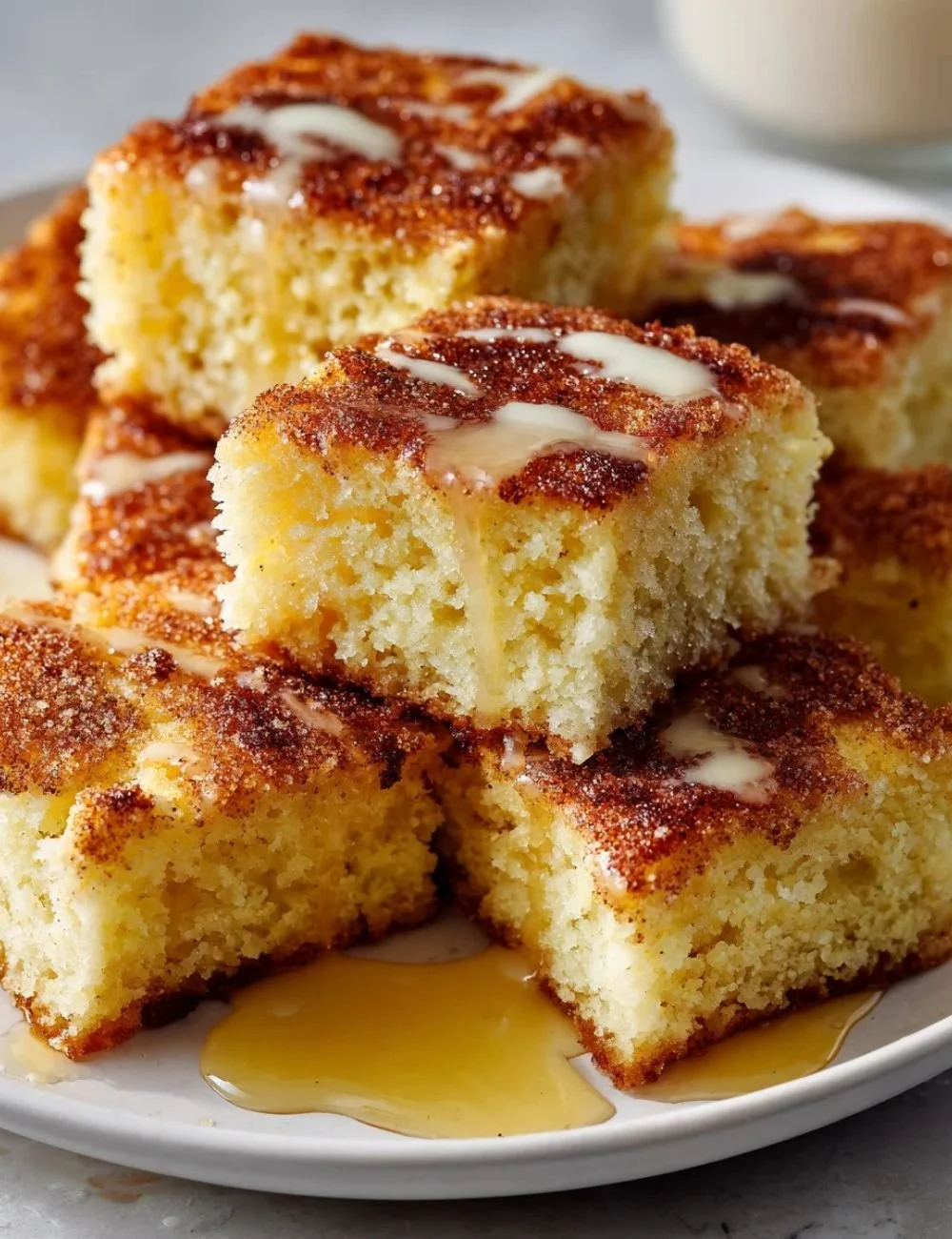 Slice of Eggnog Breakfast Cake topped with whipped cream and festive sprinkles