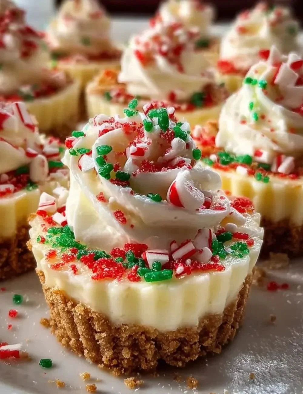 Plate of no-bake Christmas mini cheesecakes decorated with festive toppings