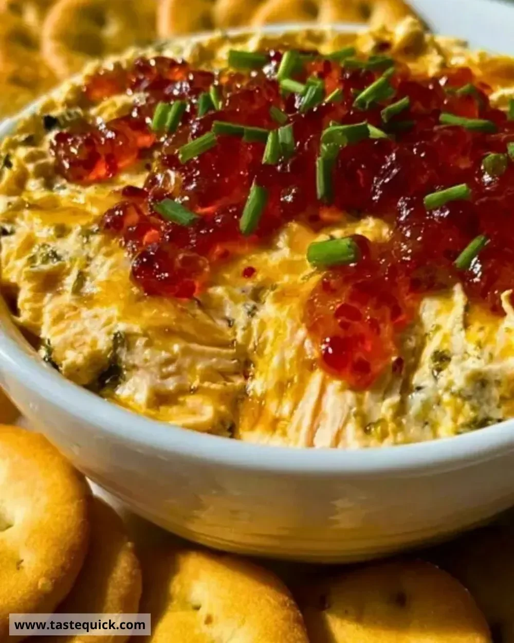 Creamy pepper jelly cheese dip served with crackers and vegetables