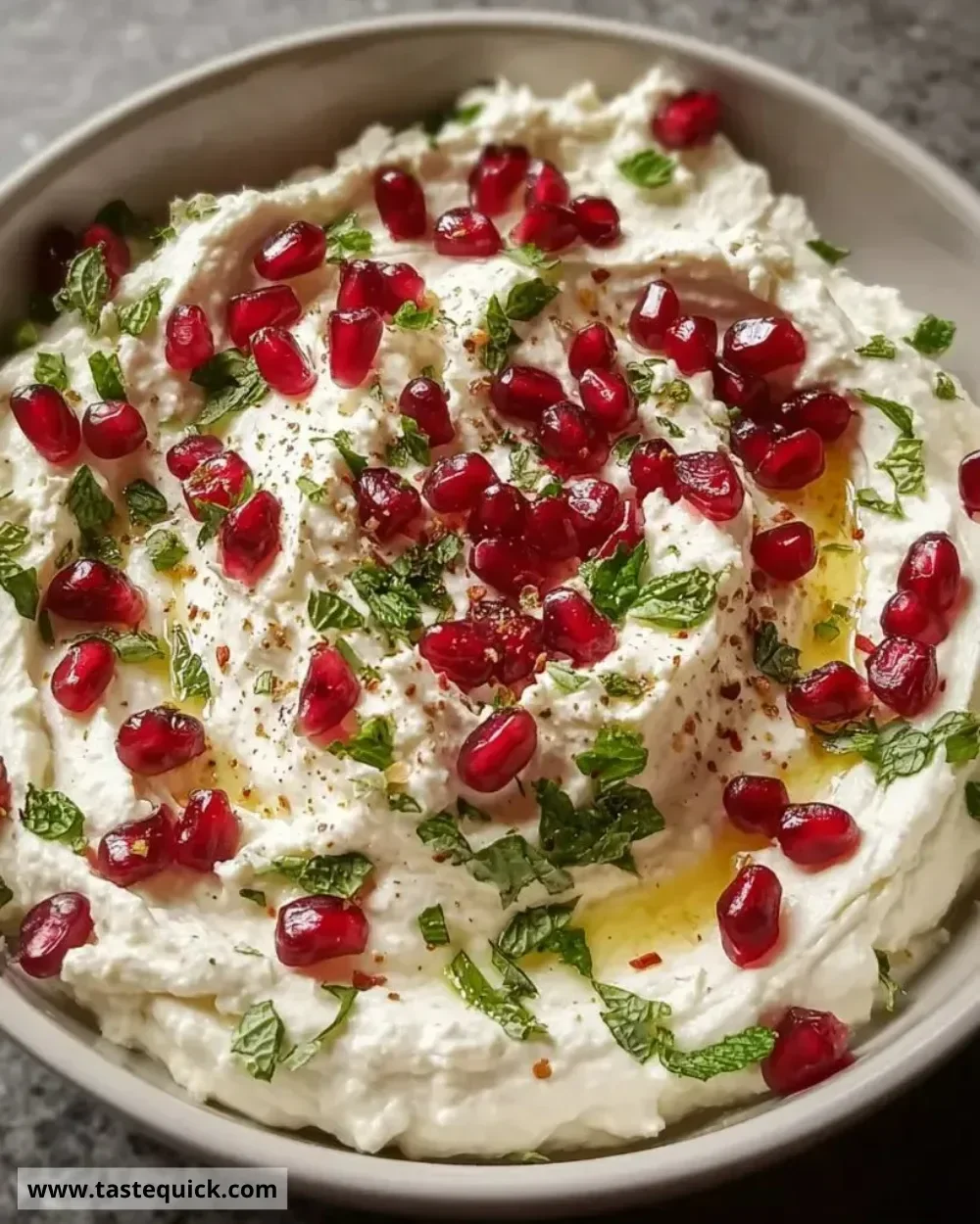 Delicious pomegranate feta cheese dip served in a bowl with pita chips