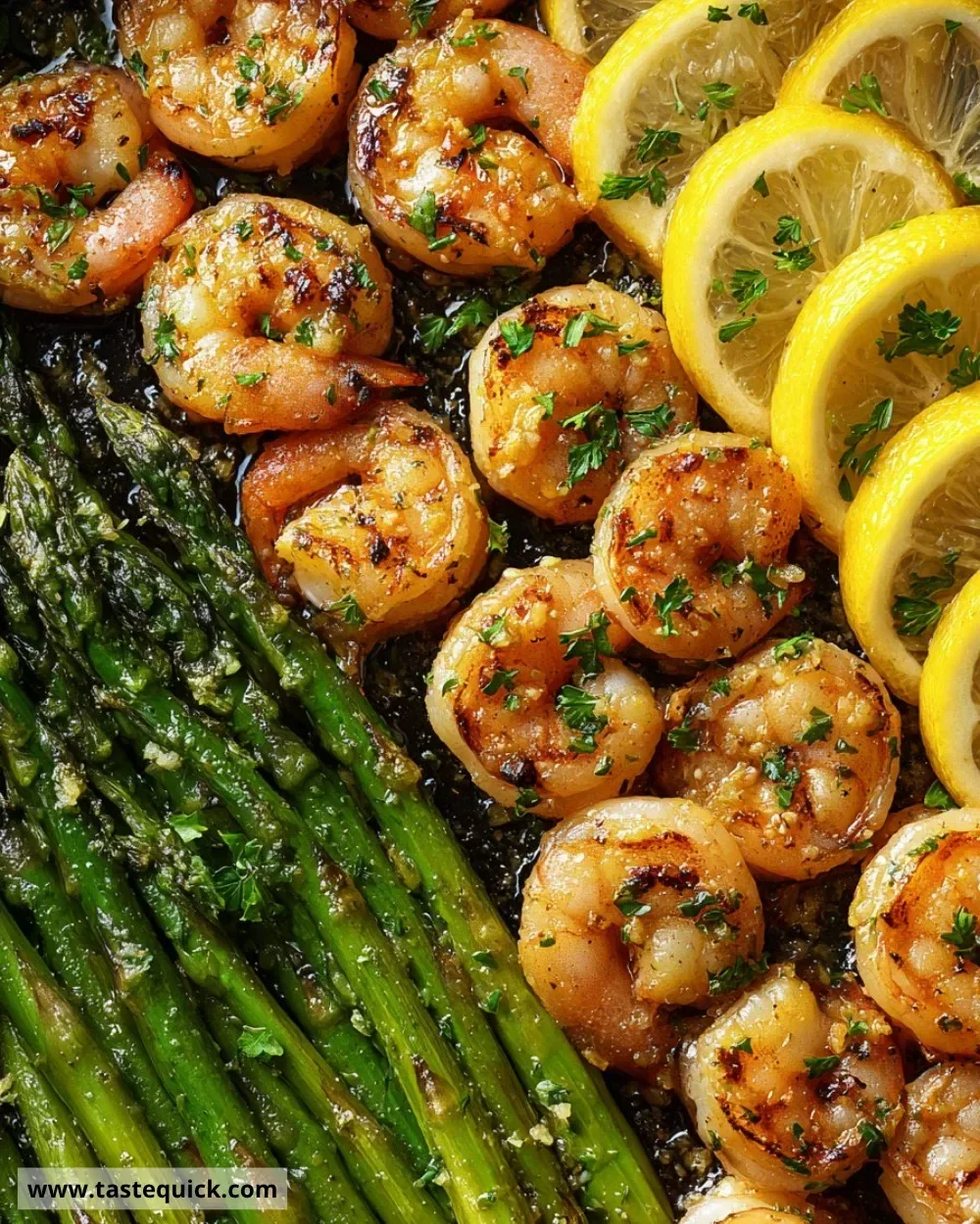Quick lemon garlic shrimp and asparagus skillet dish plated with garnish.