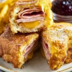 Delicious REAL DEAL Monte Cristo sandwich served with a side of berries.