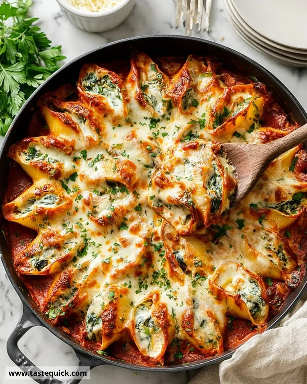Plate of delicious baked stuffed shells with cheese and herbs
