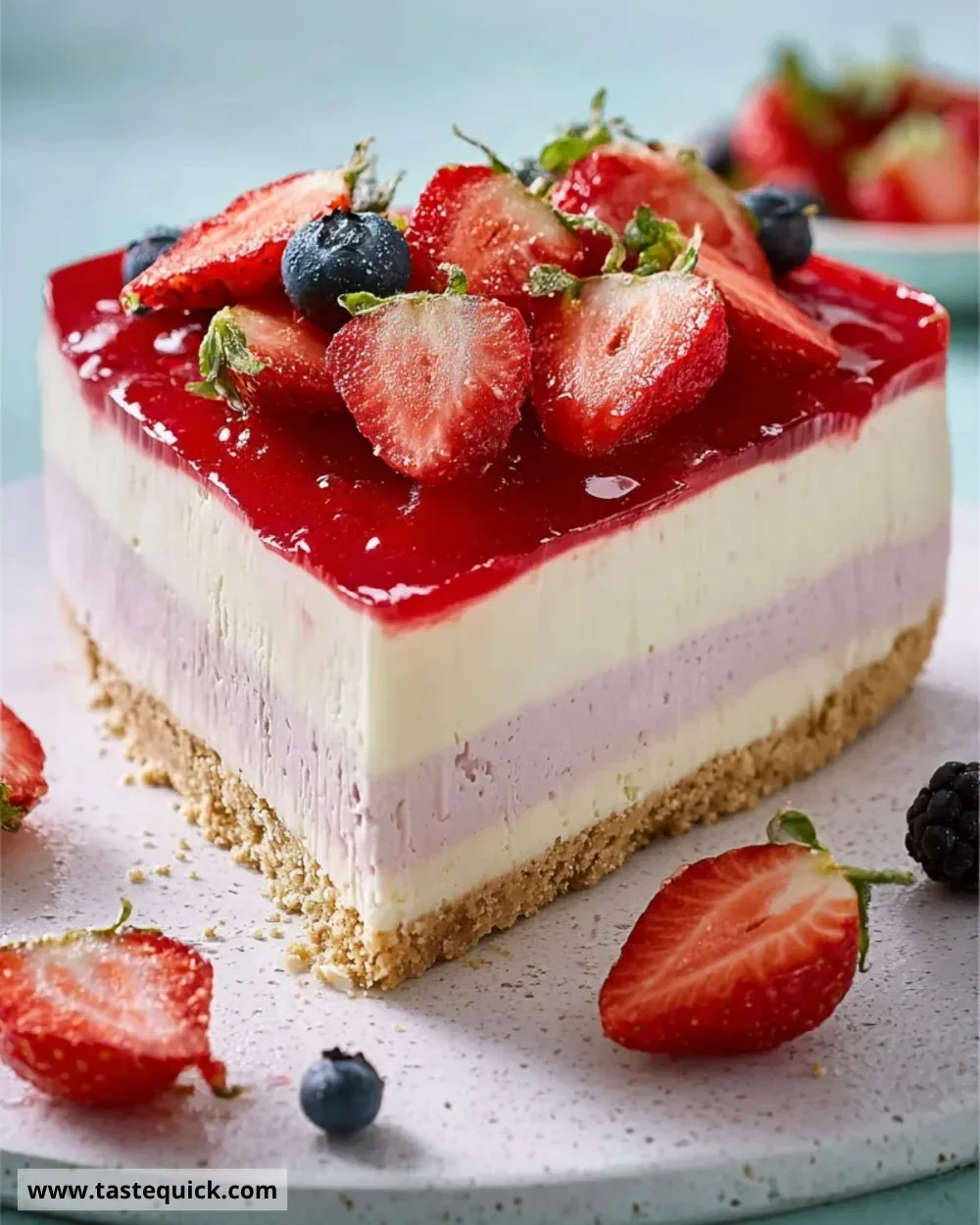 Triple-layered berry cheesecake topped with fresh berries and creamy layers
