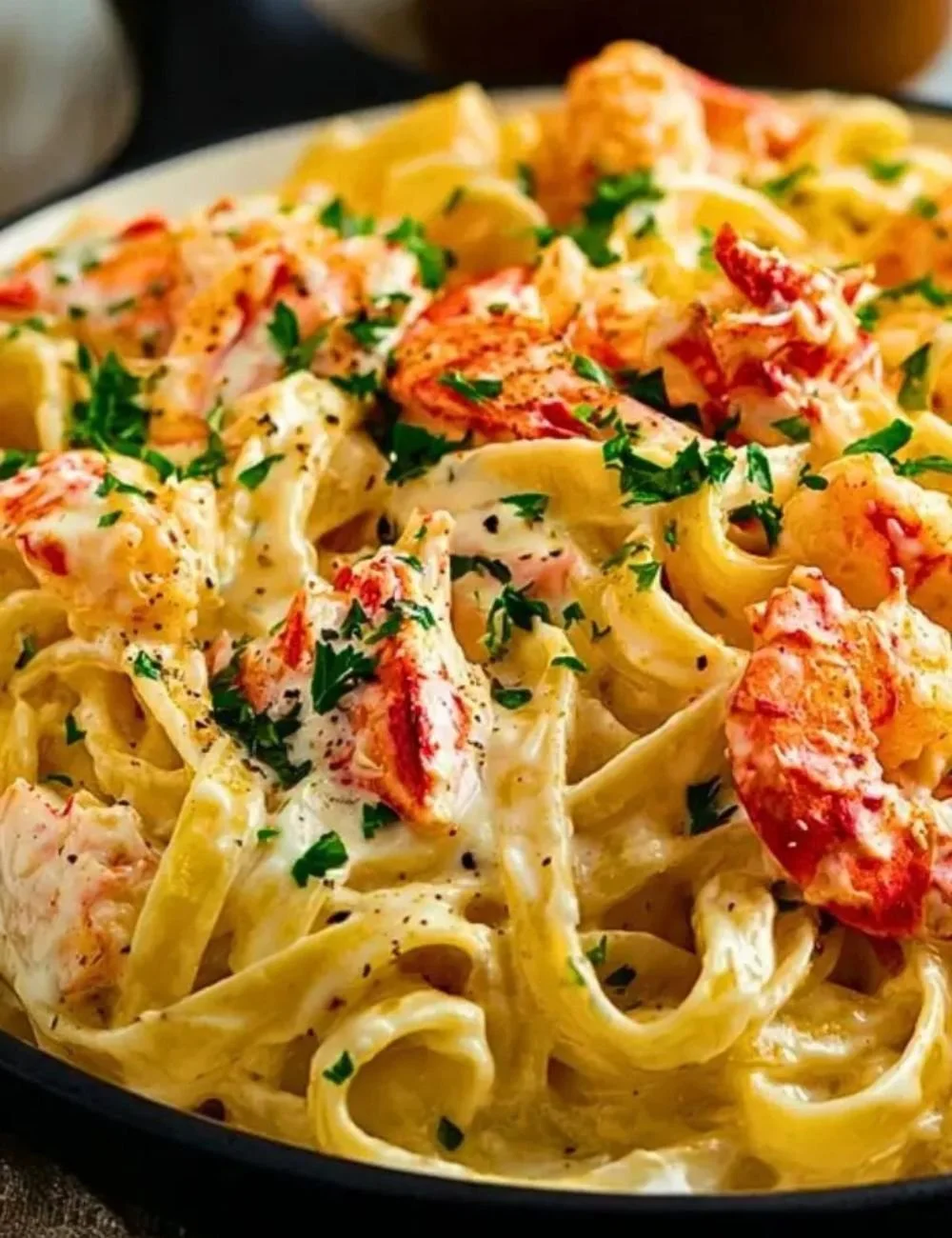 Delicious Cajun Seafood Alfredo with lobster and crab served in a creamy sauce