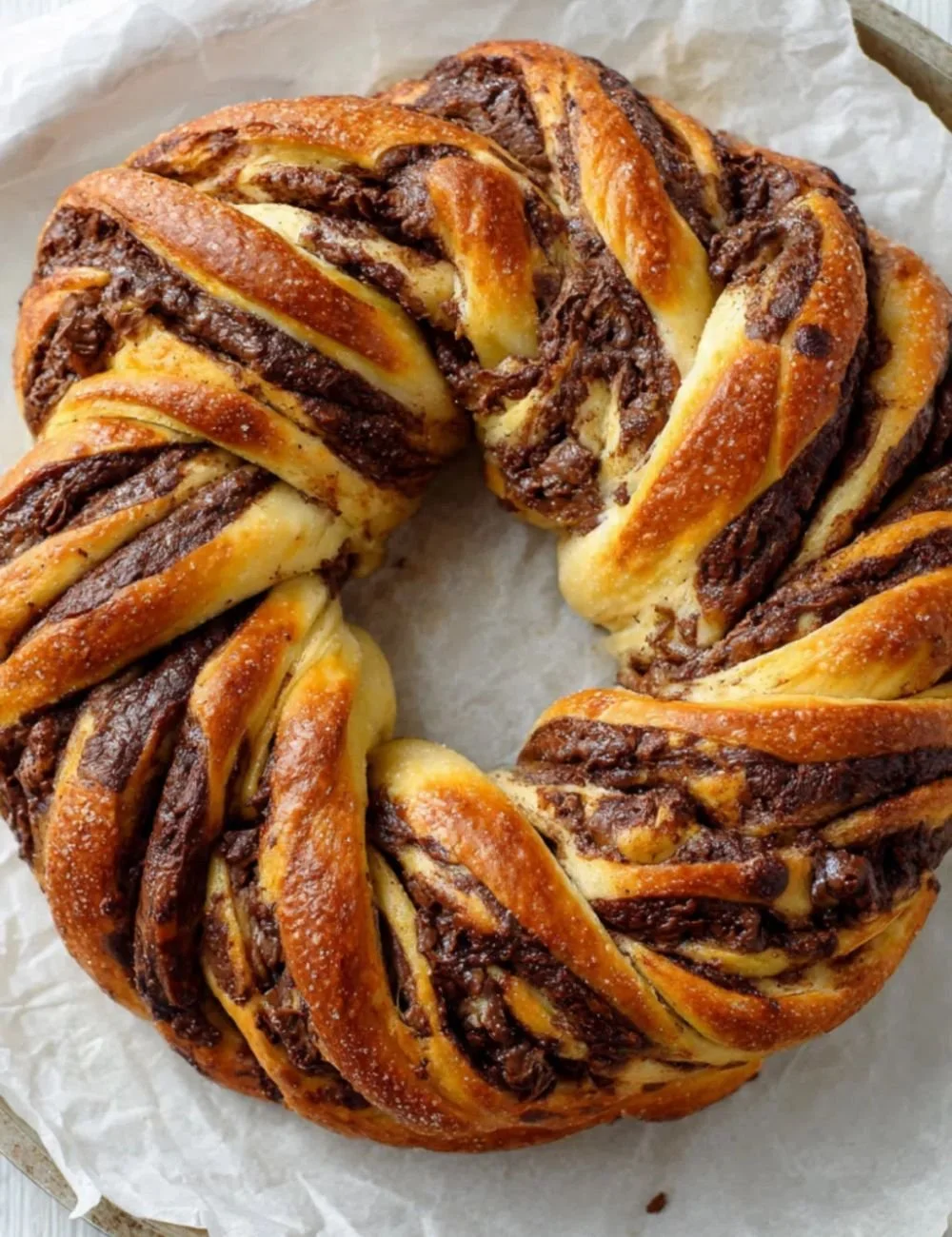 Delicious chocolate braided bread topped with chocolate drizzle and nuts