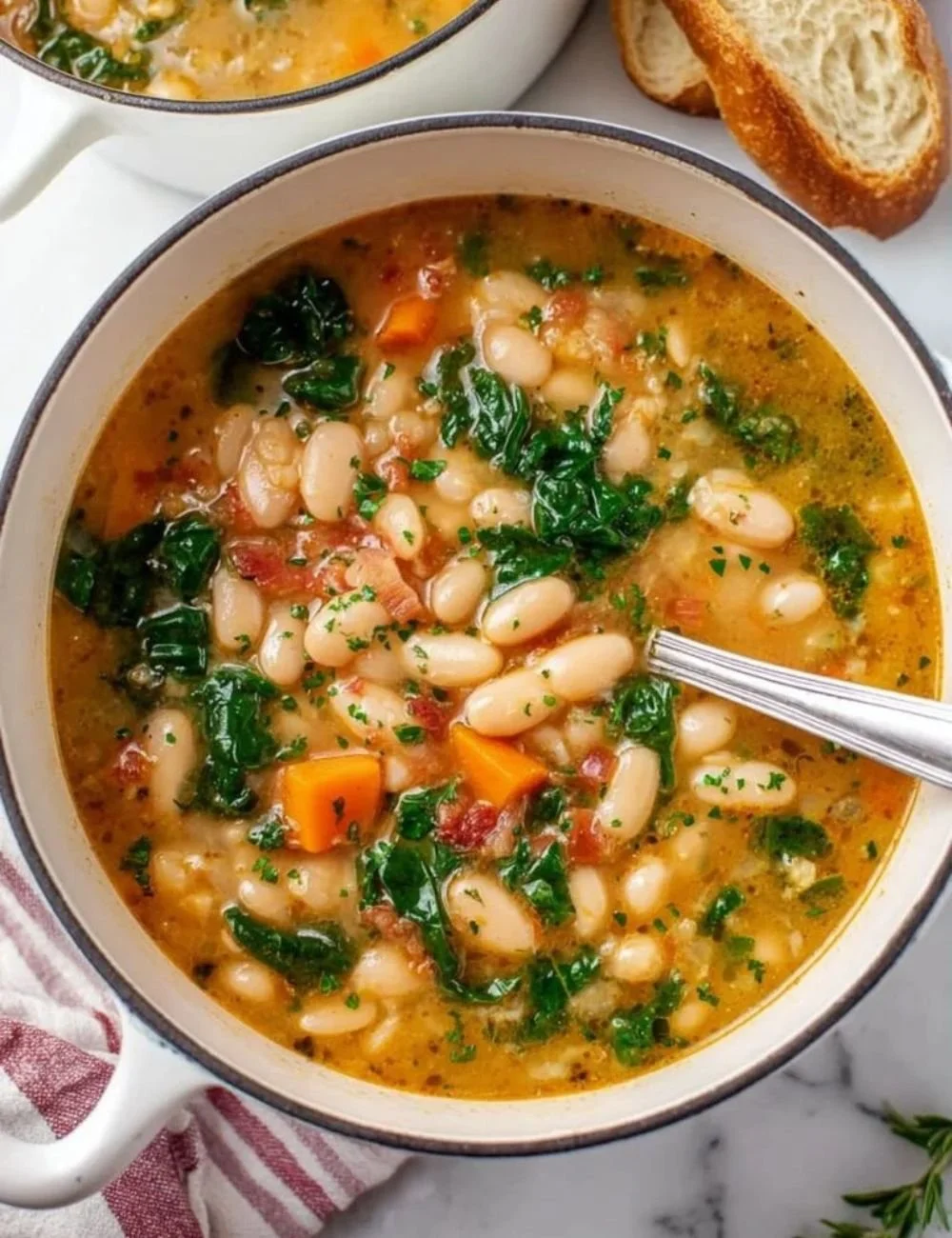 Bowl of cozy homemade white bean soup garnished with herbs and spices.