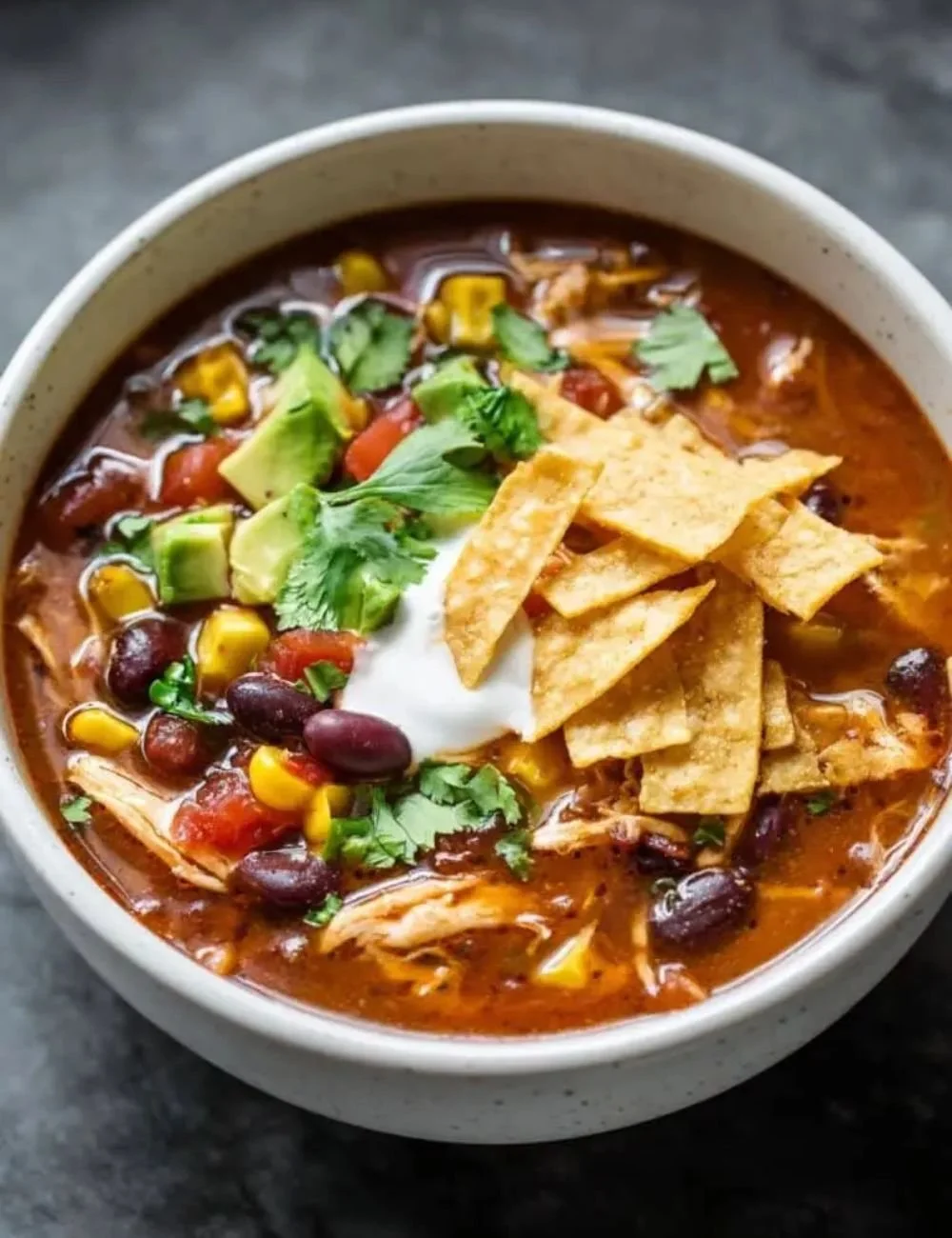 Delicious bowl of Crockpot Chicken Tortilla Soup garnished with tortilla strips