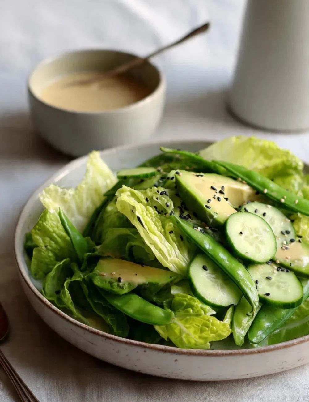 Crunchy green salad topped with miso dressing and fresh vegetables