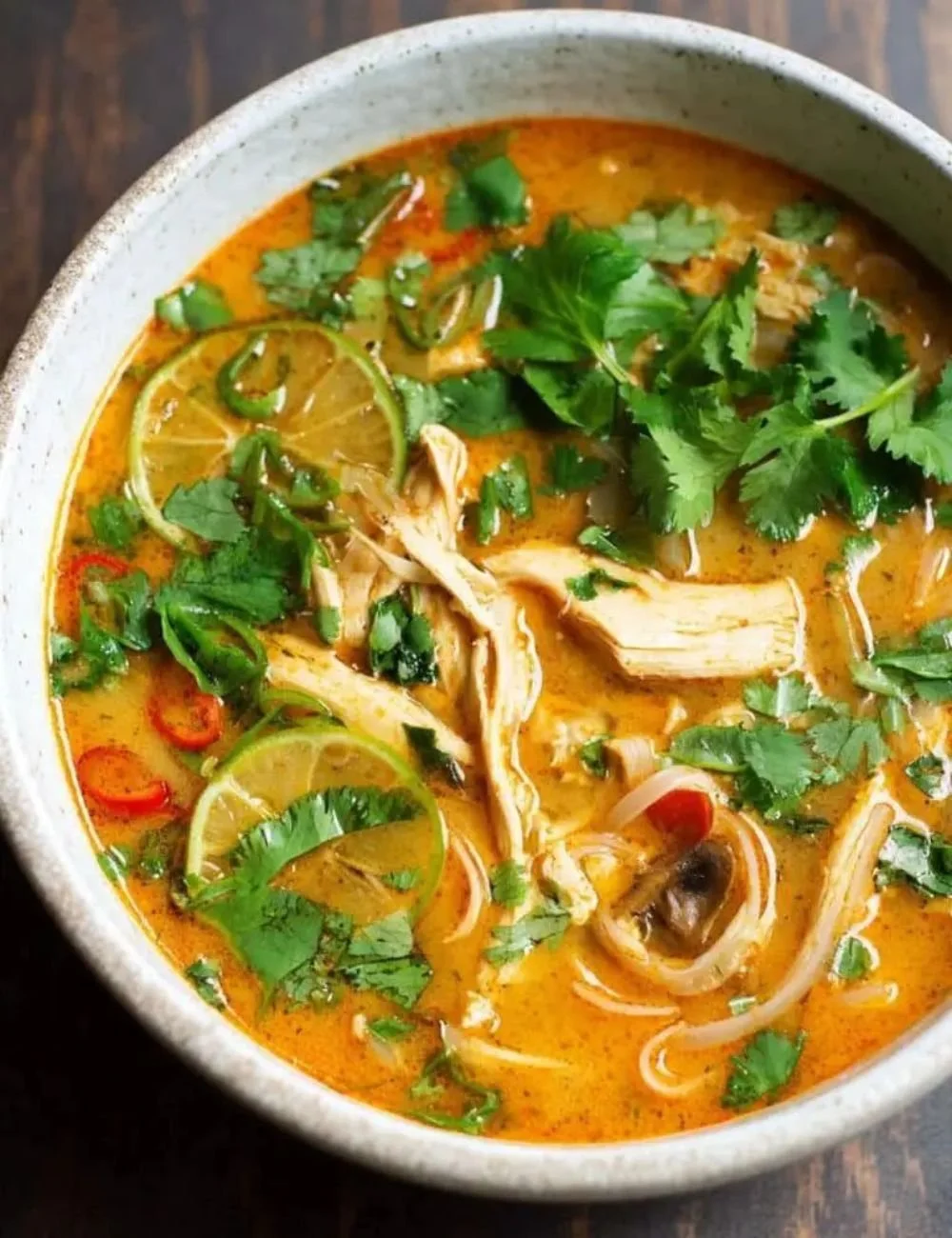 Bowl of Easy Thai Chicken Curry Soup with fresh herbs and spices