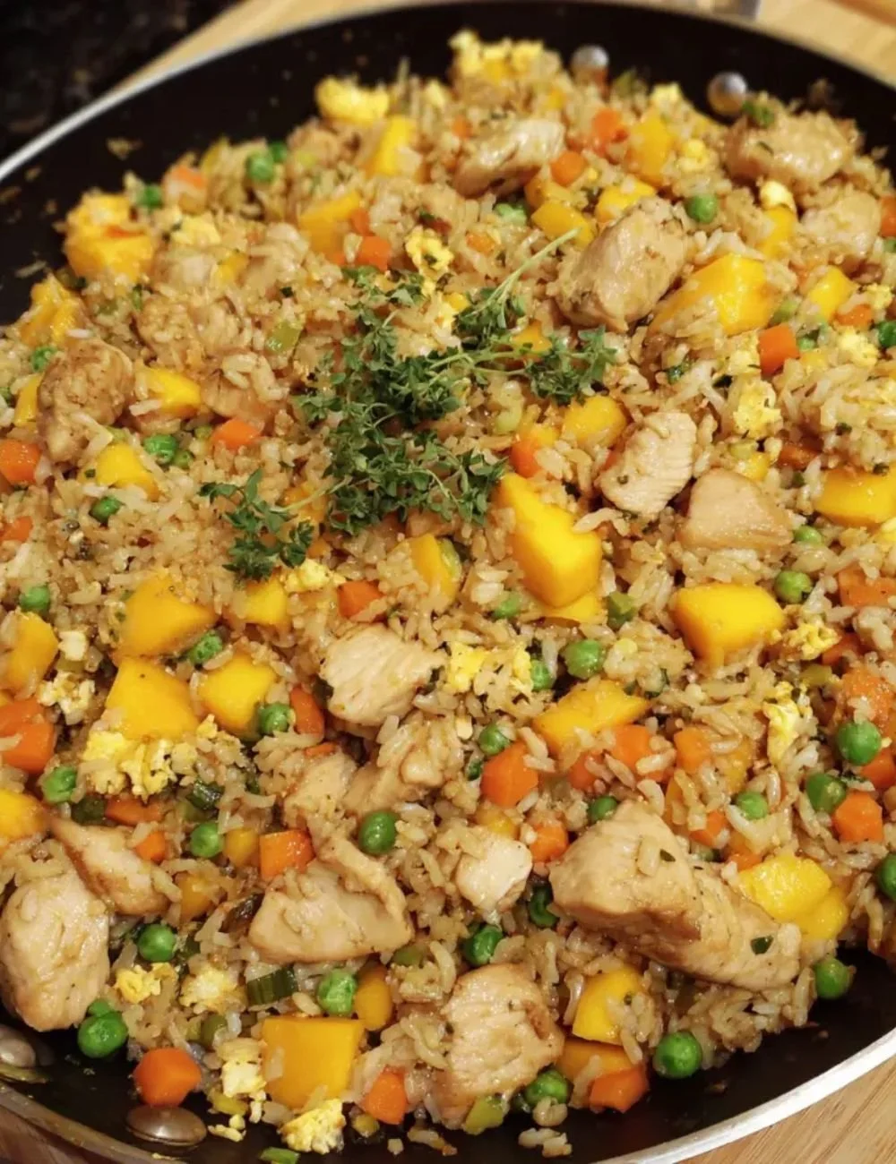Delicious mango chicken fried rice served in a bowl with vibrant colors and fresh ingredients.