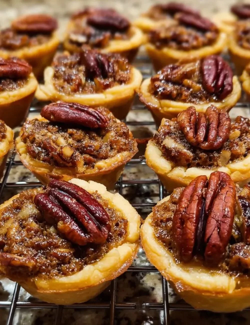 Delicious old fashioned pecan tassies on a rustic wooden table.