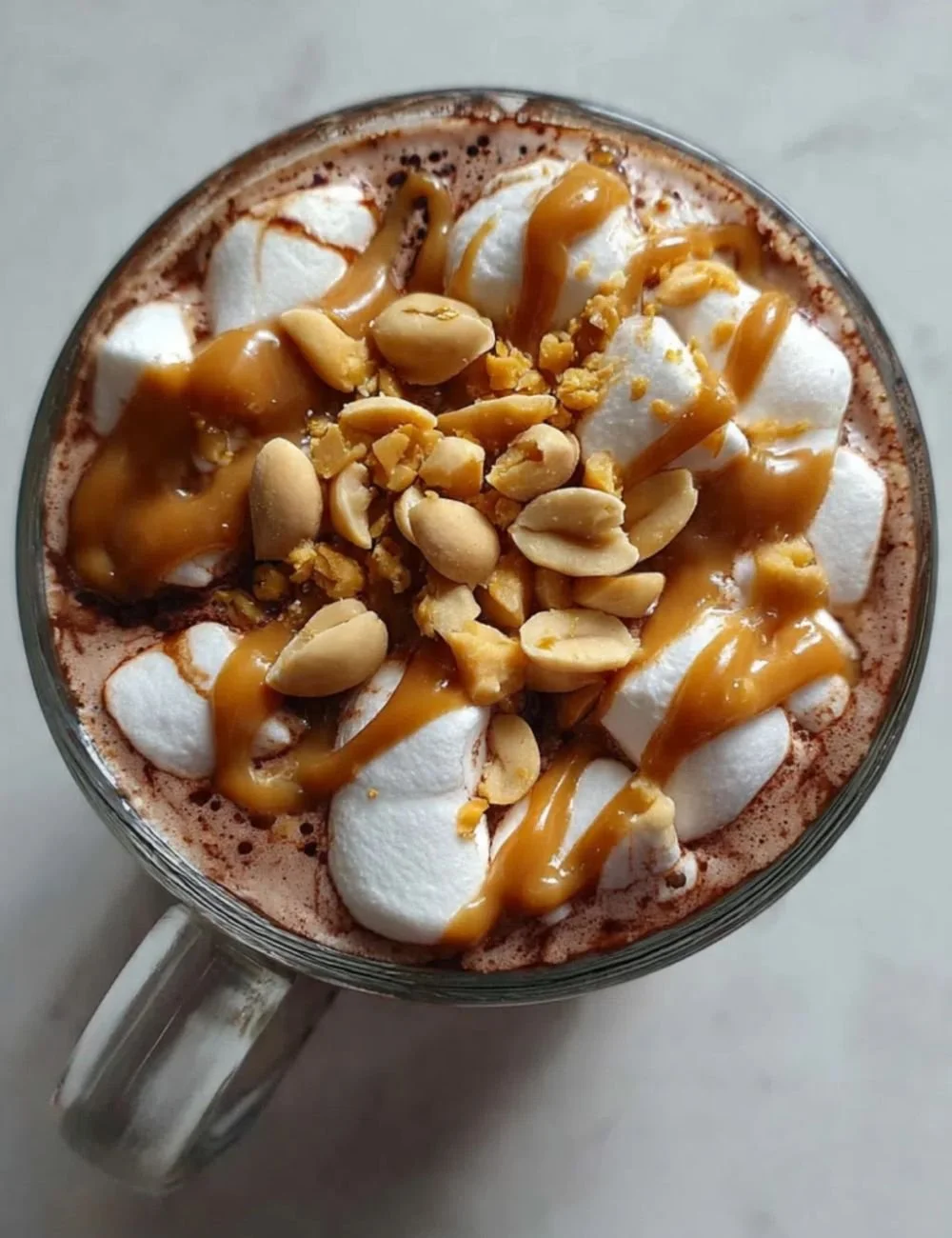 Delicious cup of peanut butter hot chocolate topped with whipped cream and chocolate shavings.