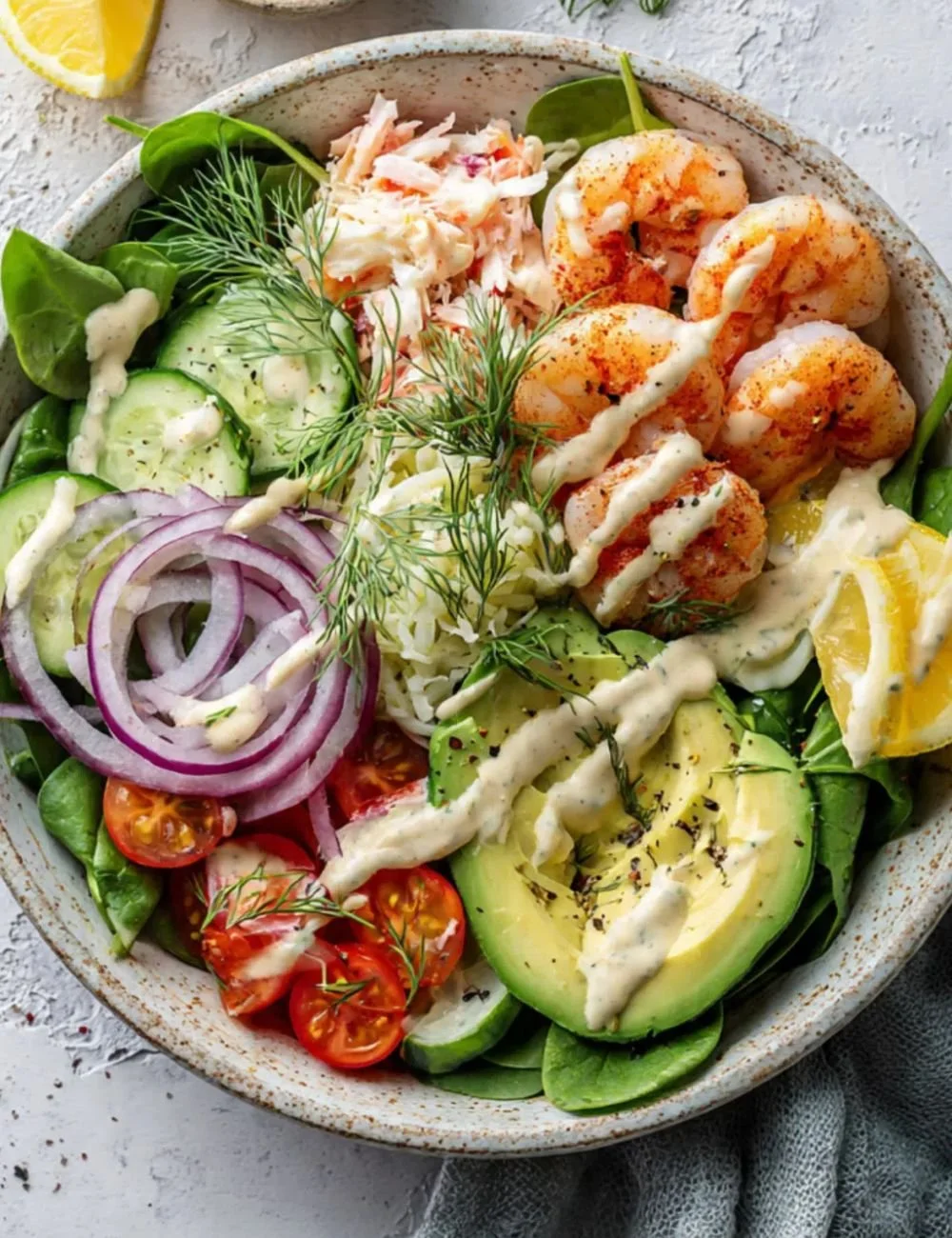 Prawn and avocado spicy salad topped with fresh herbs and dressing