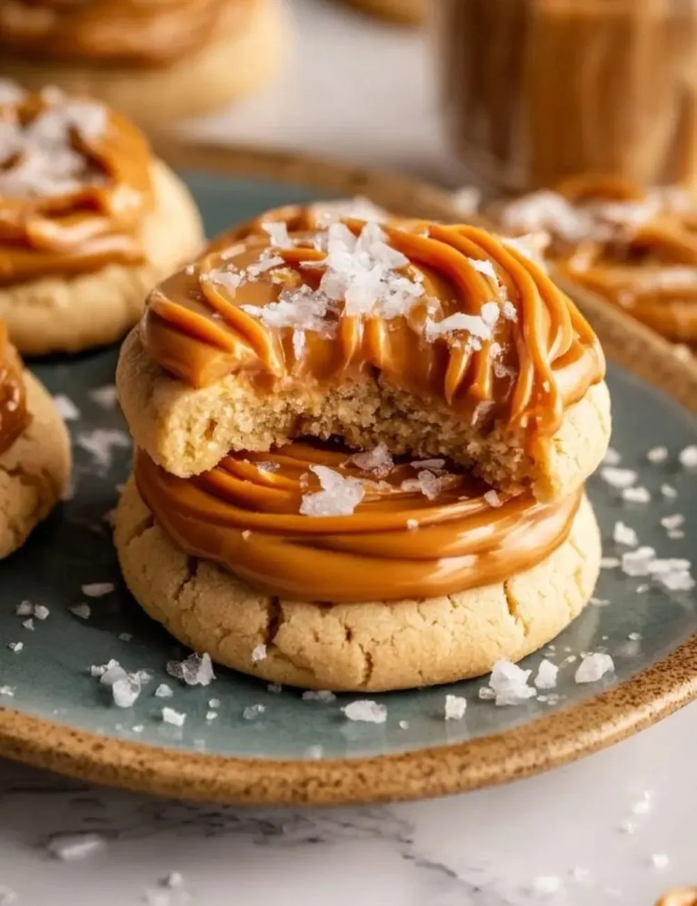 Delicious Salted Caramel Cheesecake Cookies topped with caramel drizzle