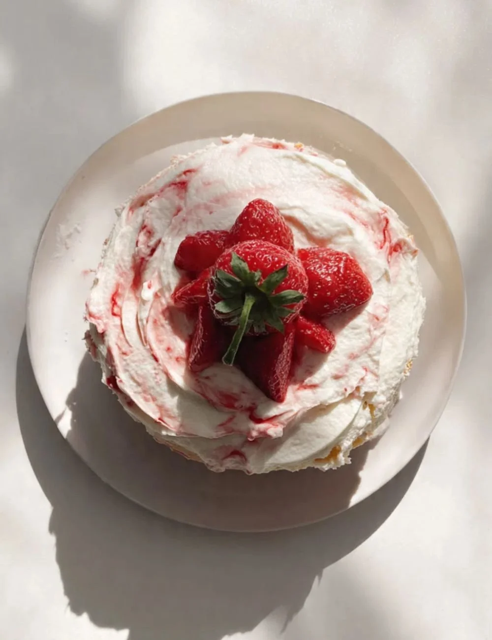 Delicious strawberry condensed milk cake topped with fresh strawberries