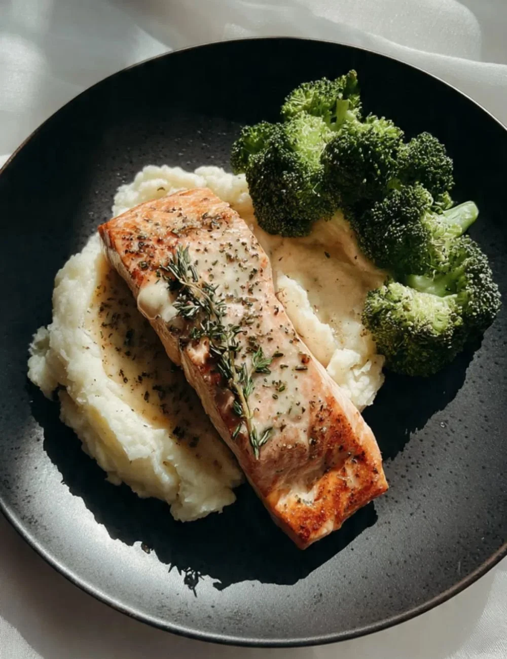 Creamy lemon garlic salmon served with crispy baby potatoes