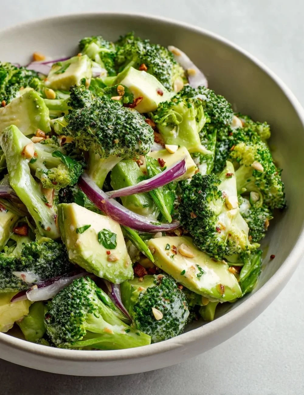Fresh Cucumber Avocado Broccoli Salad served in a bowl with dressing