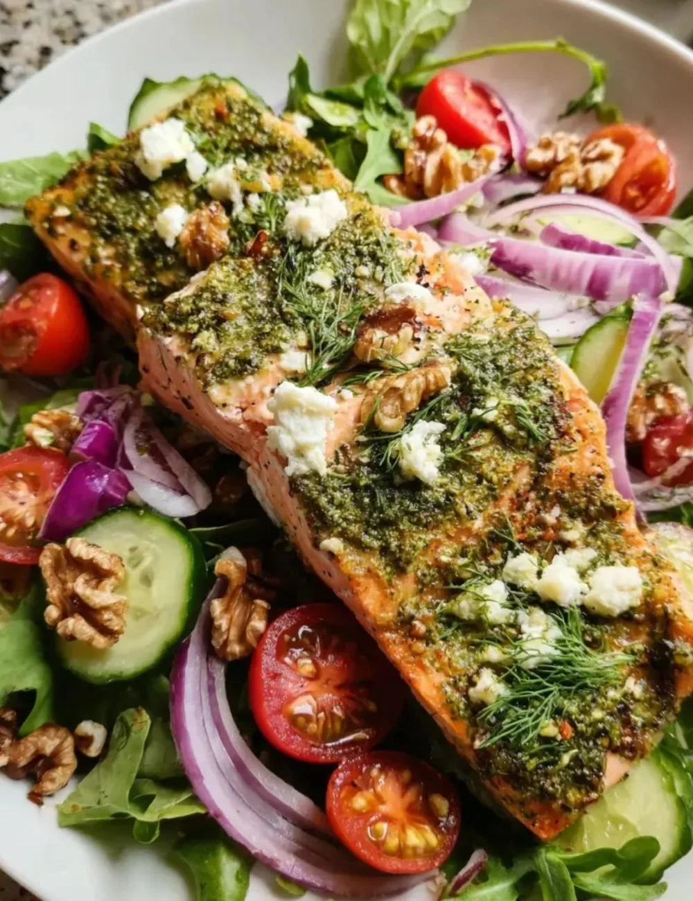 Herb-crusted salmon salad with vibrant greens and dressing