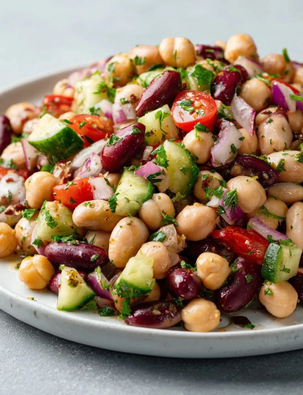Colorful Mediterranean Bean Salad with fresh vegetables and herbs in a bowl