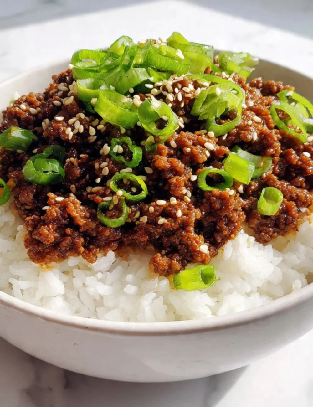 Delicious plate of Mongolian Ground Beef served with vegetables and rice.