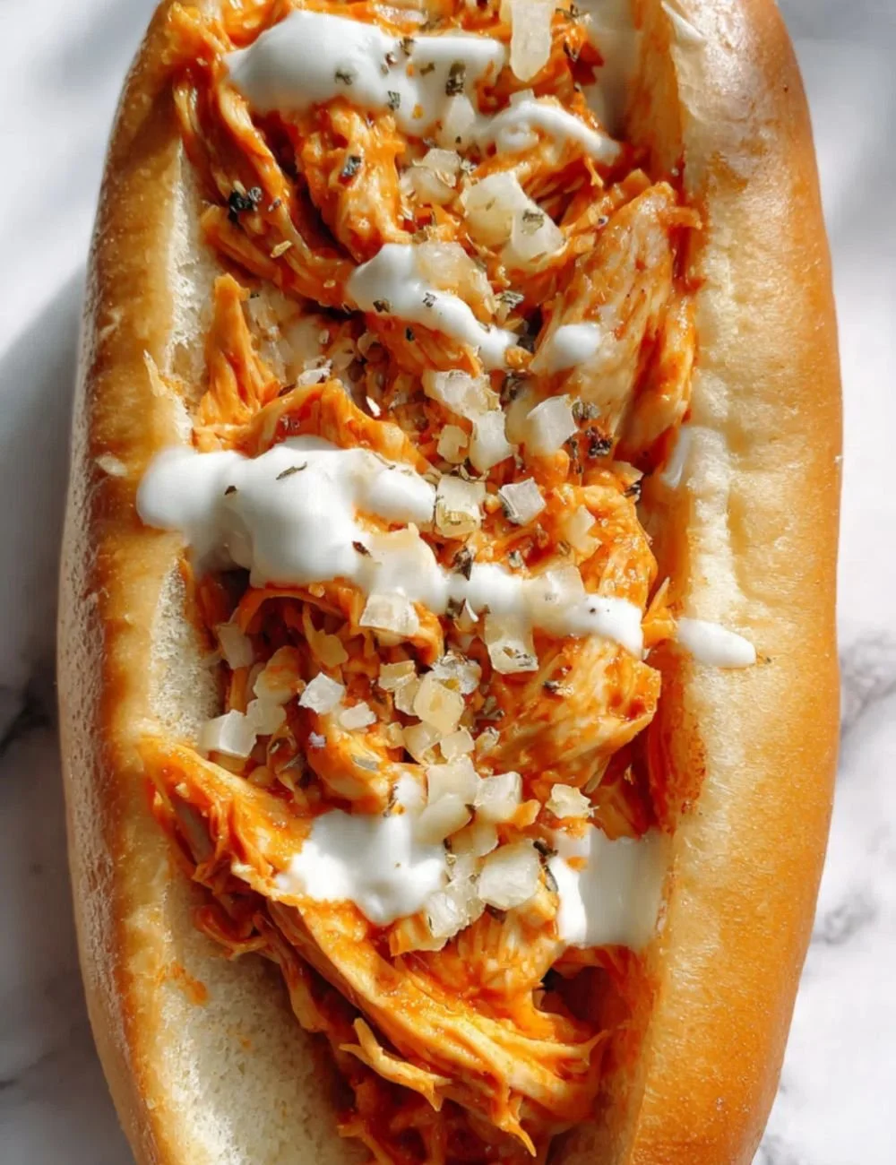 Shredded Buffalo Chicken Sandwich with spicy sauce and fresh toppings