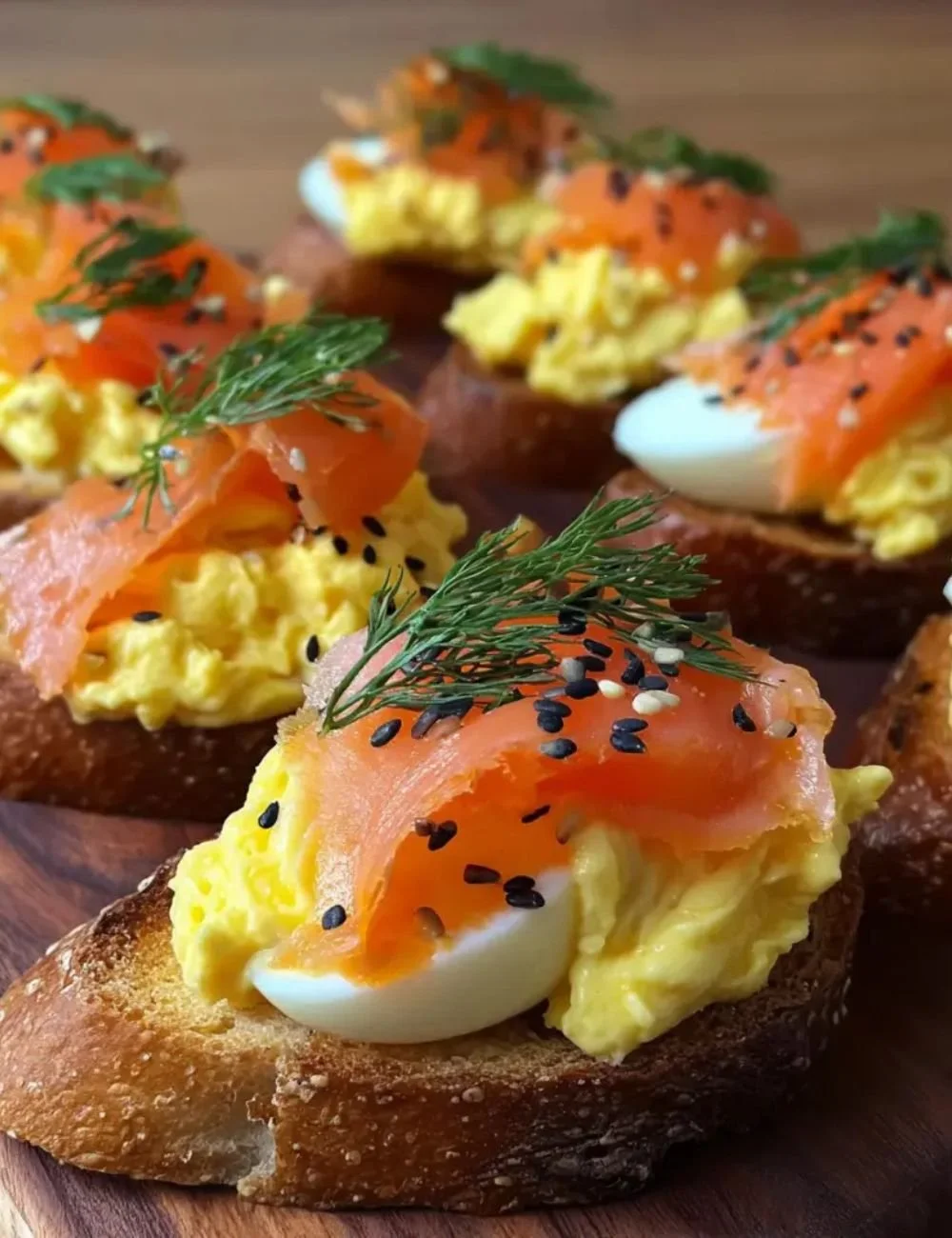 Delicious smoked salmon crostini topped with creamy egg mousse on a platter