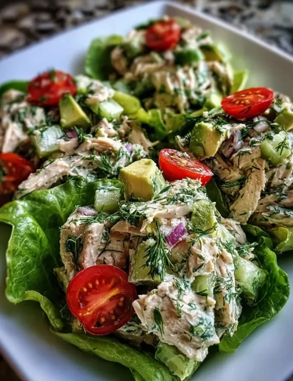 Avocado Herb Chicken Salad with fresh herbs and chicken in a bowl