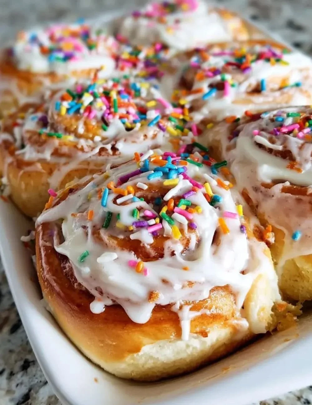 Delicious Birthday Cake Cinnamon Rolls topped with colorful frosting and sprinkles