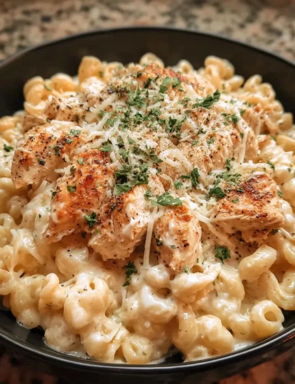 Crockpot Garlic Parmesan Chicken Pasta served in a bowl with herbs