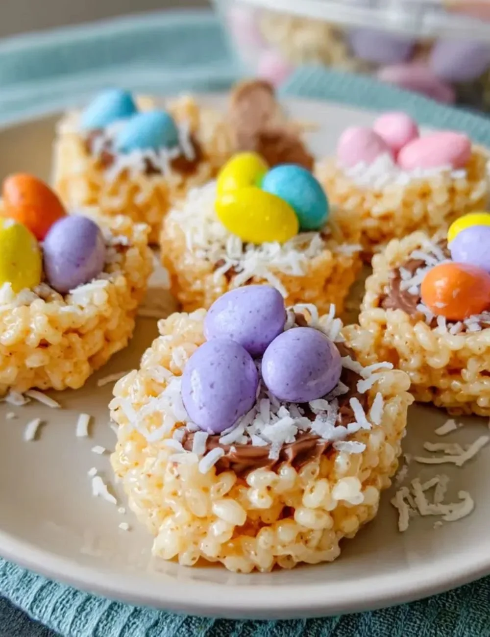 Colorful Easter Rice Krispie Nests topped with chocolate eggs.